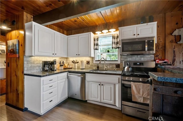 865 Bear Mtn, Big Bear City, CA 92314 - kitchen with stainless steel appliances, wooden ceiling with exposed beams, a sink, tasteful backsplash, and dark countertops