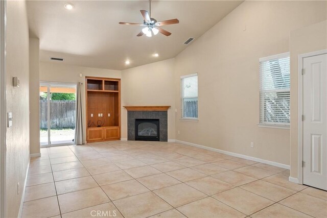 1033 Raven Ln, Chico, CA 95926 - unfurnished living room featuring ceiling fan, light tile patterned flooring, a tile fireplace, baseboards, and high vaulted ceiling