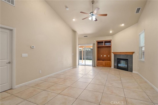 1033 Raven Ln, Chico, CA 95926 - unfurnished living room featuring plenty of natural light, light tile patterned floors, ceiling fan, a tiled fireplace, and lofted ceiling