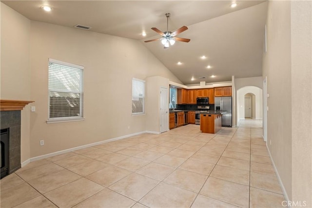1033 Raven Ln, Chico, CA 95926 - kitchen featuring stainless steel appliances, open floor plan, a ceiling fan, dark countertops, and light tile patterned floors