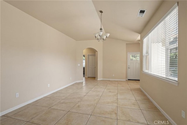 1033 Raven Ln, Chico, CA 95926 - empty room with arched walkways, a chandelier, light tile patterned flooring, lofted ceiling, and baseboards