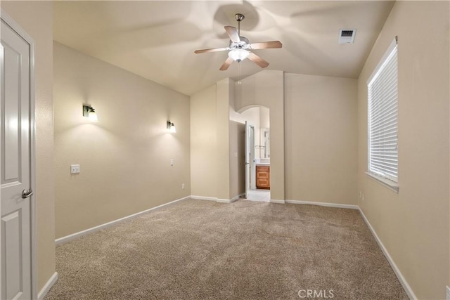 1033 Raven Ln, Chico, CA 95926 - unfurnished bedroom featuring carpet, arched walkways, baseboards, lofted ceiling, and connected bathroom