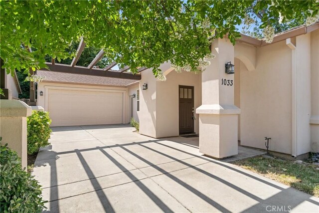 1033 Raven Ln, Chico, CA 95926 - view of front of home with stucco siding, driveway, and an attached garage