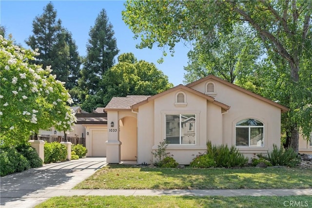 1033 Raven Ln, Chico, CA 95926 - view of front of home with a garage, stucco siding, concrete driveway, and a front yard