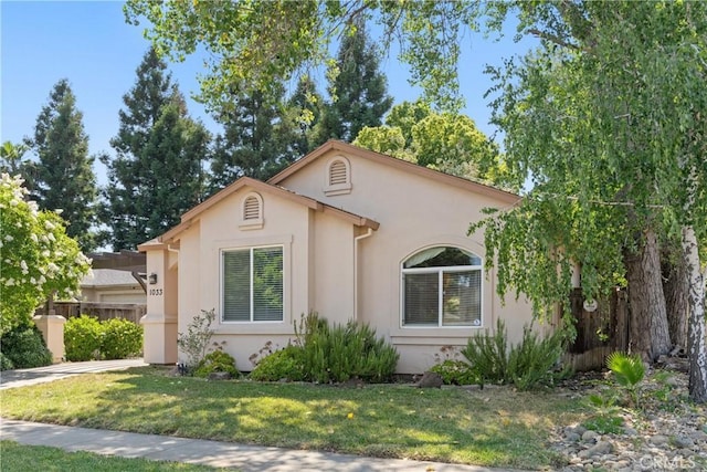 1033 Raven Ln, Chico, CA 95926 - mediterranean / spanish-style home featuring stucco siding, a front yard, driveway, and a garage