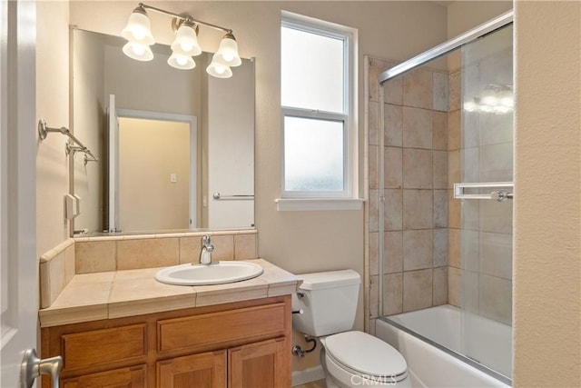 1033 Raven Ln, Chico, CA 95926 - bathroom featuring vanity, toilet, healthy amount of natural light, and combined bath / shower with glass door