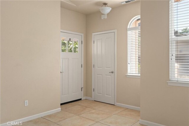 1033 Raven Ln, Chico, CA 95926 - entrance foyer with light tile patterned floors, healthy amount of natural light, and baseboards