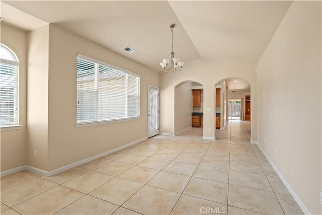 1033 Raven Ln, Chico, CA 95926 - spare room with arched walkways, light tile patterned flooring, a chandelier, lofted ceiling, and baseboards