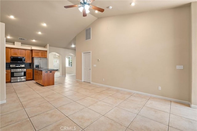 1033 Raven Ln, Chico, CA 95926 - kitchen with stainless steel appliances, arched walkways, open floor plan, light tile patterned floors, and a ceiling fan