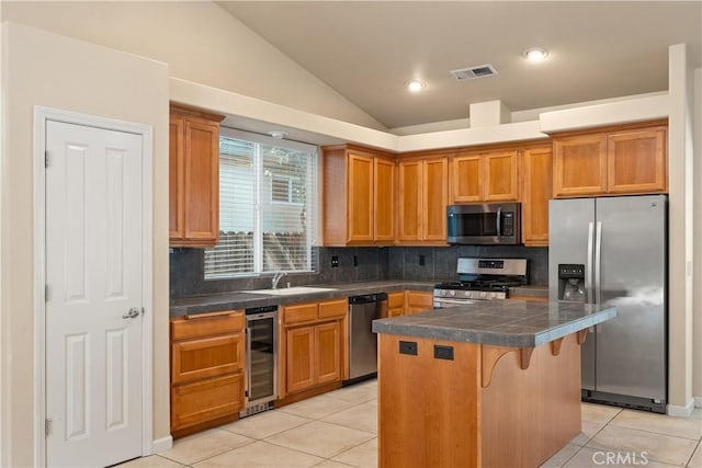 1033 Raven Ln, Chico, CA 95926 - kitchen featuring appliances with stainless steel finishes, wine cooler, lofted ceiling, decorative backsplash, and light tile patterned flooring