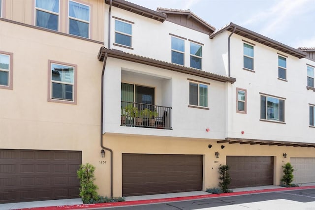 1807 Mesquite Way, Oceanside, CA 92056 - rear view of property with a garage and stucco siding