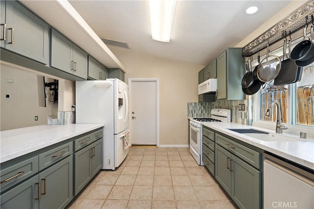 1361 Lindsey, San Jacinto, CA 92583 - kitchen featuring white appliances, a sink, vaulted ceiling, light countertops, and decorative backsplash