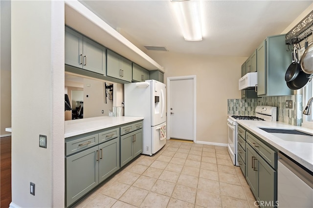 1361 Lindsey, San Jacinto, CA 92583 - kitchen with white appliances, a sink, light countertops, decorative backsplash, and baseboards