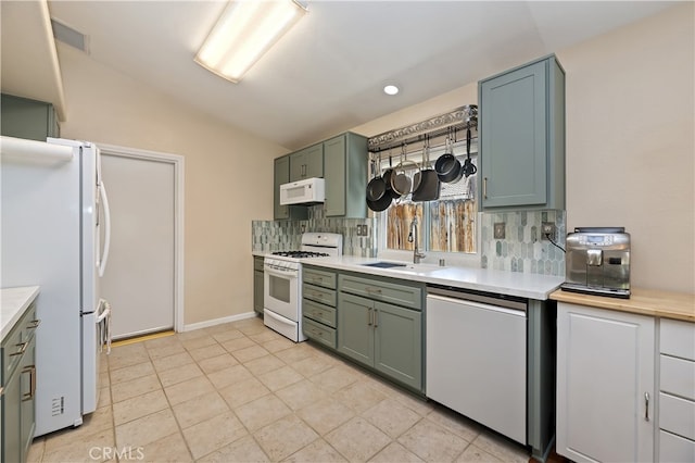 1361 Lindsey, San Jacinto, CA 92583 - kitchen with white appliances, light countertops, green cabinets, vaulted ceiling, and recessed lighting