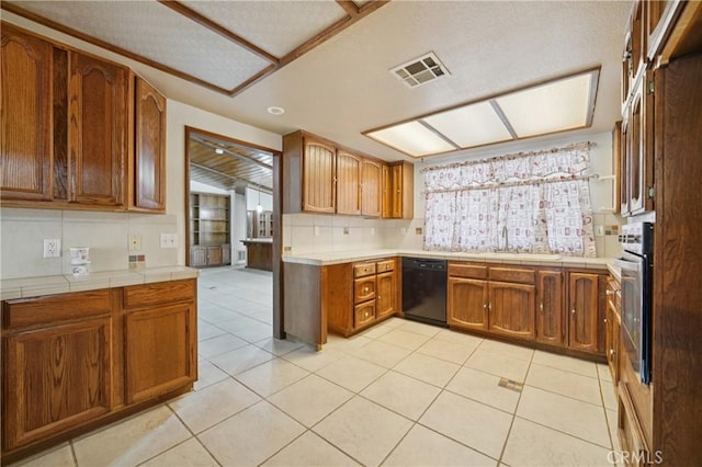 14676 Poplar St, Hesperia, CA 92345 - kitchen with black dishwasher, decorative backsplash, brown cabinets, stainless steel oven, and tile countertops