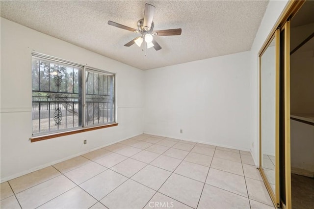 14676 Poplar St, Hesperia, CA 92345 - unfurnished bedroom featuring a textured ceiling, light tile patterned flooring, a closet, and ceiling fan