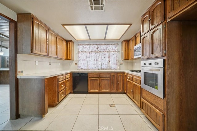 14676 Poplar St, Hesperia, CA 92345 - kitchen with stainless steel appliances, tile counters, tasteful backsplash, and plenty of natural light