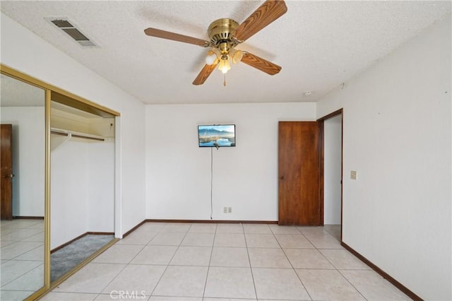 14676 Poplar St, Hesperia, CA 92345 - unfurnished bedroom with a closet, baseboards, a textured ceiling, ceiling fan, and light tile patterned flooring