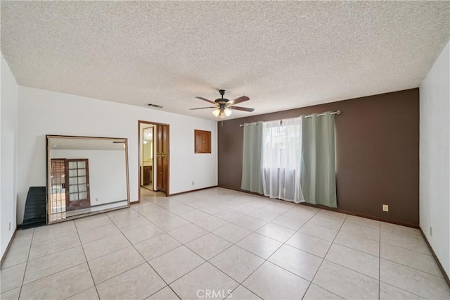 14676 Poplar St, Hesperia, CA 92345 - spare room with ceiling fan, a textured ceiling, baseboards, and light tile patterned floors