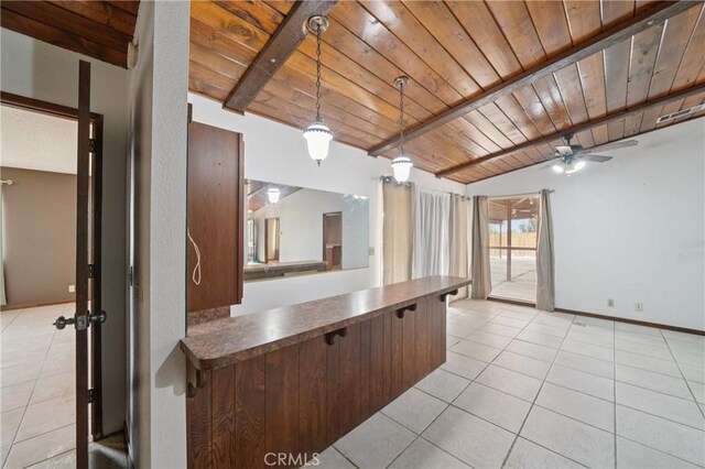 14676 Poplar St, Hesperia, CA 92345 - kitchen featuring wood ceiling with exposed beams, light tile patterned floors, a ceiling fan, dark countertops, and hanging light fixtures