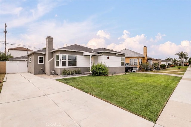 2804 W 84th St, Inglewood, CA 90305 - view of front of house featuring concrete driveway, a gate, stucco siding, and a chimney