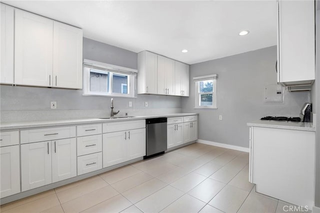 2804 W 84th St, Inglewood, CA 90305 - kitchen featuring stainless steel dishwasher, a sink, light countertops, baseboards, and white cabinets