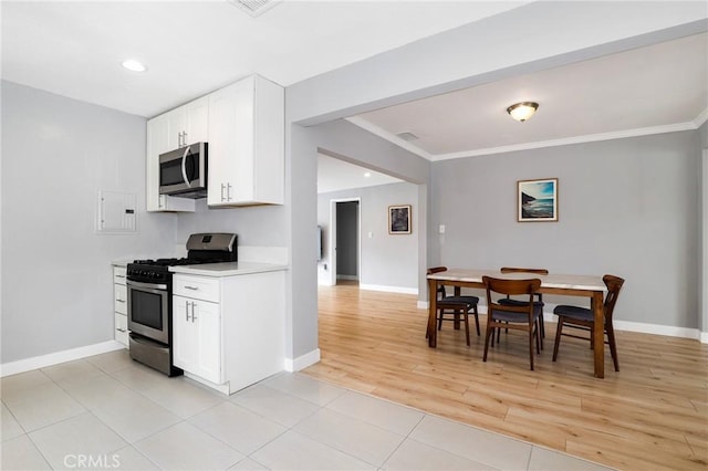 2804 W 84th St, Inglewood, CA 90305 - kitchen with appliances with stainless steel finishes, baseboards, ornamental molding, white cabinetry, and light countertops