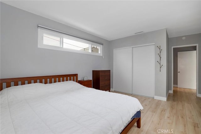 2804 W 84th St, Inglewood, CA 90305 - bedroom featuring a closet, light wood-style floors, and baseboards