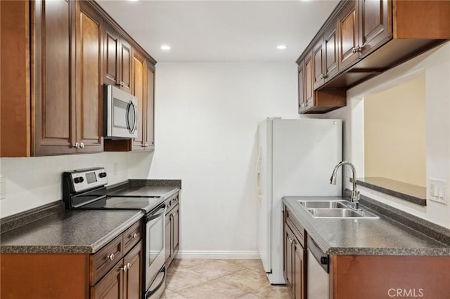 310 S Miraleste Dr Unit 69, San Pedro, CA 90732 - kitchen with appliances with stainless steel finishes, a sink, dark countertops, recessed lighting, and baseboards