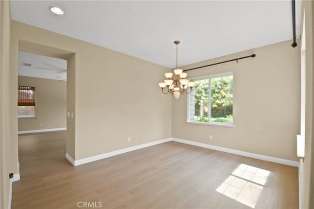 12632 Chimney Rock Dr, Rancho Cucamonga, CA 91739 - empty room with a chandelier, wood finished floors, and baseboards