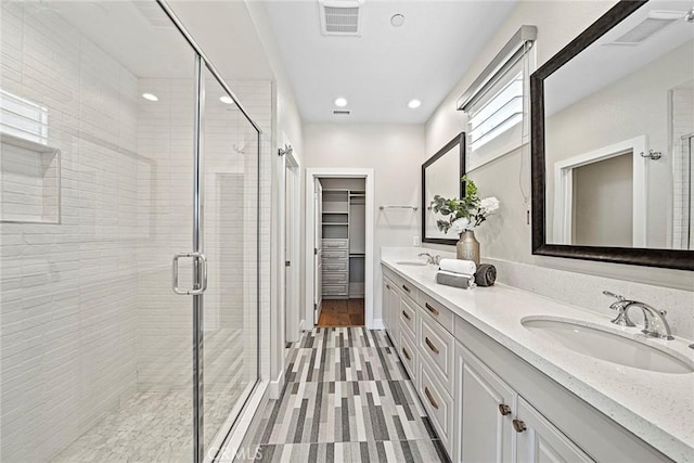26290 Paseo Sillin, San Juan Capistrano, CA 92675 - bathroom featuring double vanity, a shower stall, a walk in closet, and recessed lighting