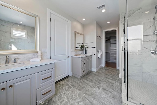 26290 Paseo Sillin, San Juan Capistrano, CA 92675 - full bath with marble finish floors, a marble finish shower, two vanities, a spacious closet, and recessed lighting