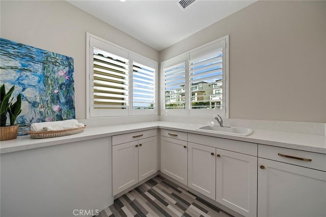 26290 Paseo Sillin, San Juan Capistrano, CA 92675 - kitchen with a sink, light countertops, and white cabinetry