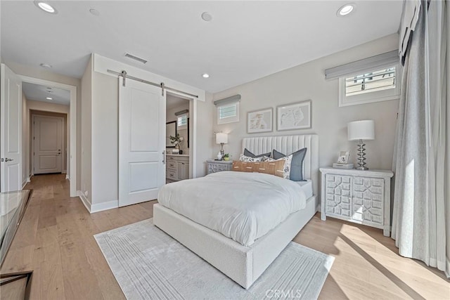 26290 Paseo Sillin, San Juan Capistrano, CA 92675 - bedroom featuring a barn door, light wood-style floors, recessed lighting, baseboards, and ensuite bathroom