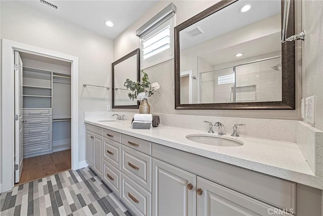 26290 Paseo Sillin, San Juan Capistrano, CA 92675 - full bathroom with double vanity, tiled shower, a spacious closet, and recessed lighting