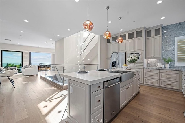 26290 Paseo Sillin, San Juan Capistrano, CA 92675 - kitchen with appliances with stainless steel finishes, a sink, a center island with sink, wood finished floors, and recessed lighting