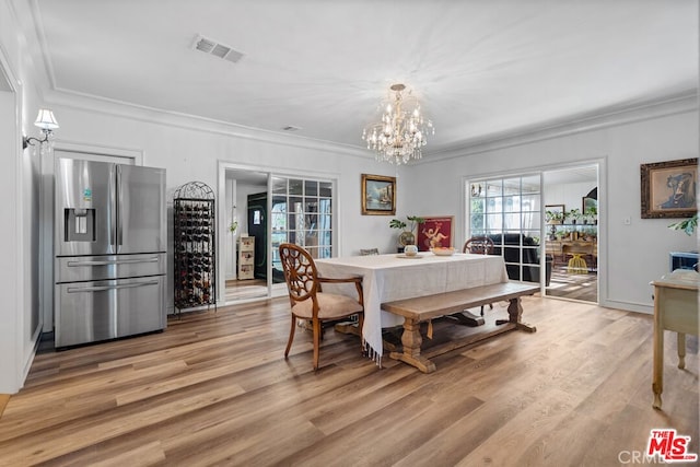 728 S Windsor Blvd, Los Angeles, CA 90005 - dining room featuring ornamental molding, a chandelier, and light wood-style floors