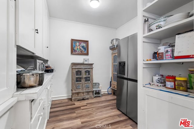 728 S Windsor Blvd, Los Angeles, CA 90005 - kitchen with stainless steel fridge with ice dispenser, white cabinets, crown molding, open shelves, and light wood-style floors