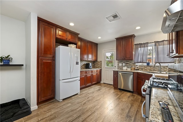 3075 Ronald, Riverside, CA 92506 - kitchen featuring appliances with stainless steel finishes, light wood-style flooring, decorative backsplash, island exhaust hood, and recessed lighting