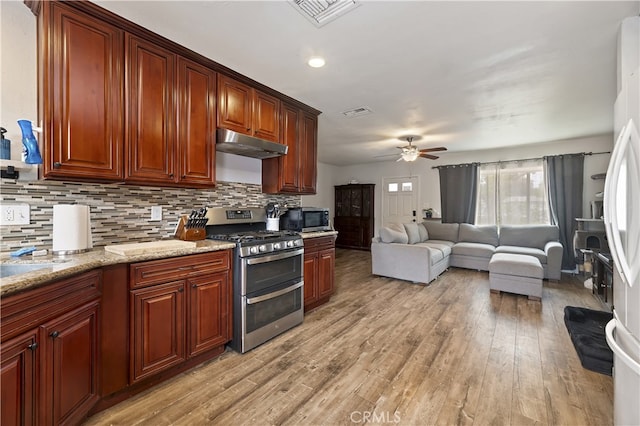 3075 Ronald, Riverside, CA 92506 - kitchen with appliances with stainless steel finishes, under cabinet range hood, ceiling fan, light wood-style flooring, and tasteful backsplash