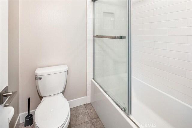 71 Einstein Way, Irvine, CA 92618 - bathroom featuring toilet, baseboards, and shower / bath combination with glass door