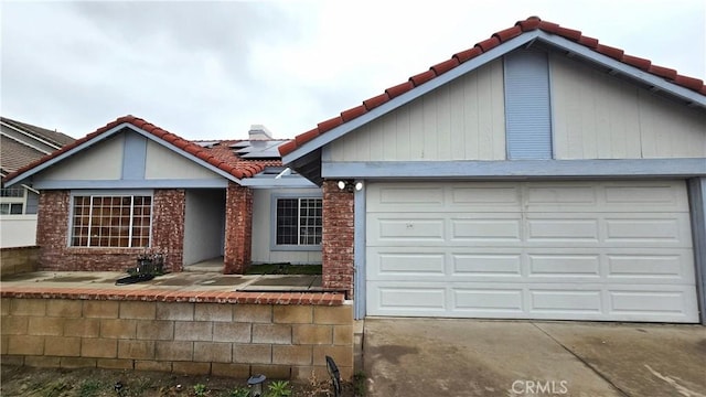 1822 Glover St, Redlands, CA 92374 - ranch-style home with a tile roof, solar panels, concrete driveway, an attached garage, and brick siding