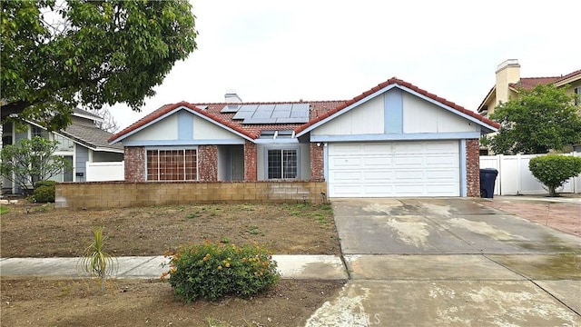 1822 Glover St, Redlands, CA 92374 - view of front of home featuring a tile roof, brick siding, an attached garage, and roof mounted solar panels