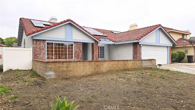 1822 Glover St, Redlands, CA 92374 - view of front facade featuring a chimney, a tiled roof, and an attached garage