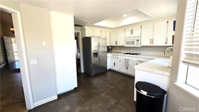 1822 Glover St, Redlands, CA 92374 - kitchen featuring white appliances, a sink, tile counters, a raised ceiling, and white cabinetry