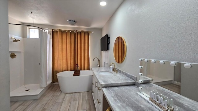1822 Glover St, Redlands, CA 92374 - bathroom with a freestanding tub, vanity, a shower with shower curtain, wood finished floors, and a textured wall