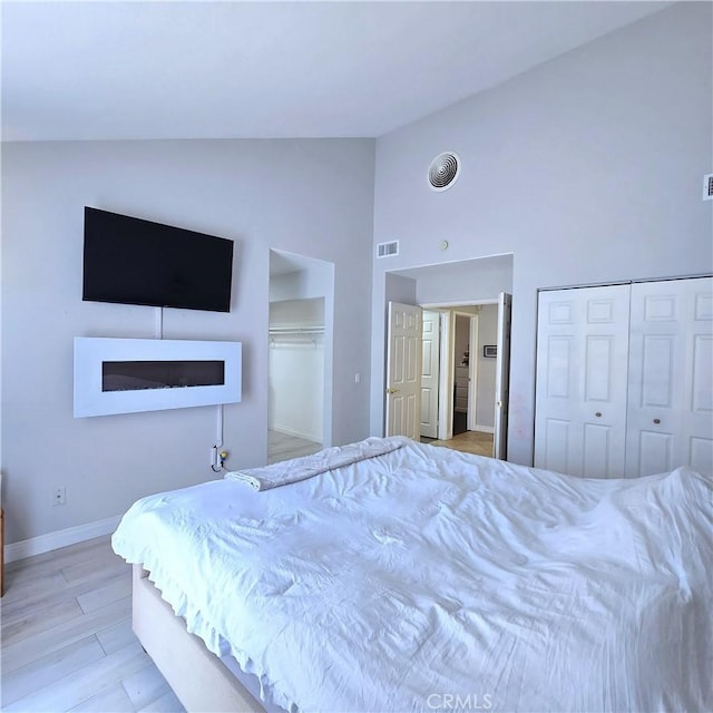 1822 Glover St, Redlands, CA 92374 - bedroom with high vaulted ceiling, baseboards, and wood finished floors