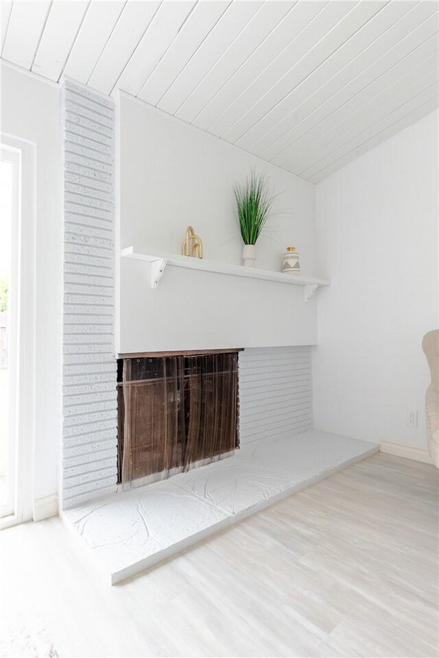 5921 Los Ramos Cir, Buena Park, CA 90620 - unfurnished living room featuring wood finished floors and a fireplace with raised hearth