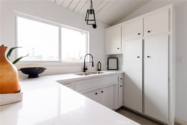 5921 Los Ramos Cir, Buena Park, CA 90620 - kitchen featuring lofted ceiling, white cabinets, and light countertops