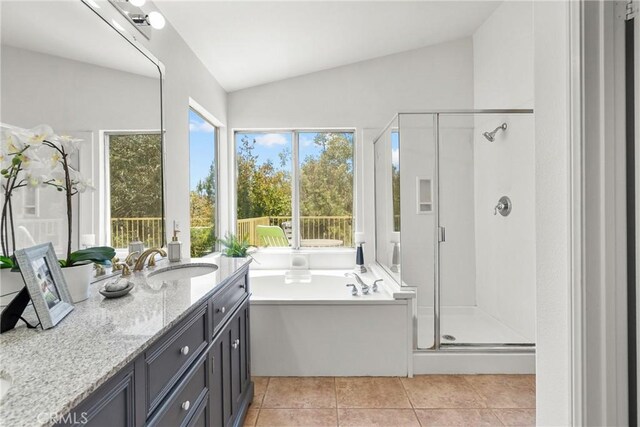 27831 Silverton Ct, Valencia, CA 91354 - full bathroom with vaulted ceiling, a shower stall, vanity, a garden tub, and tile patterned floors